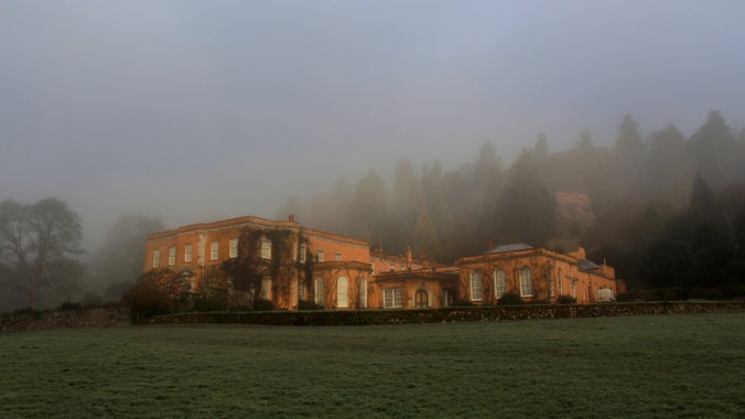 Morning winter mist surrounding the house at Killerton, Devon
